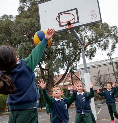 Students playing basketball at St Fidelis Primary School Coburg